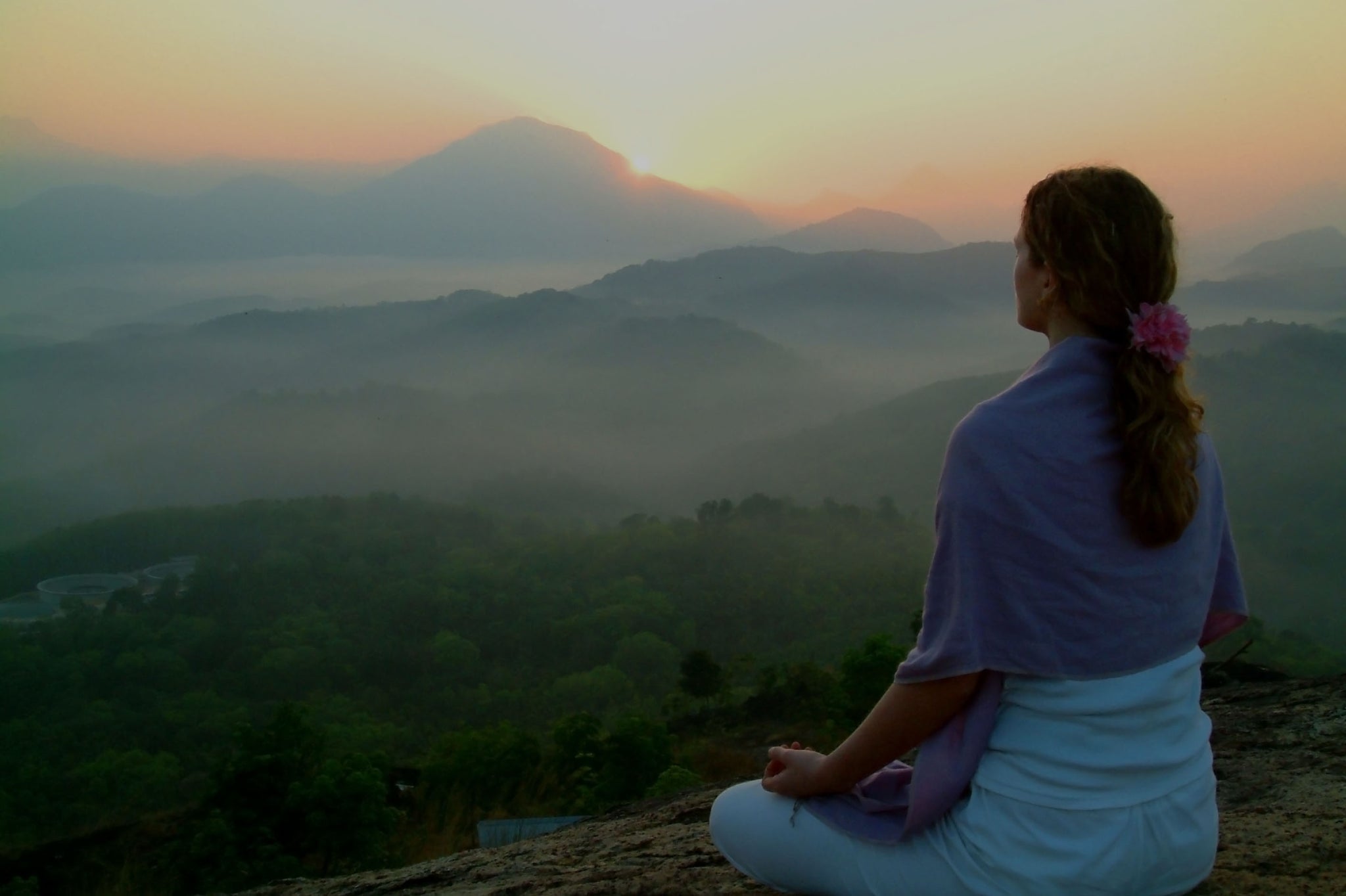 woman meditates in mountains